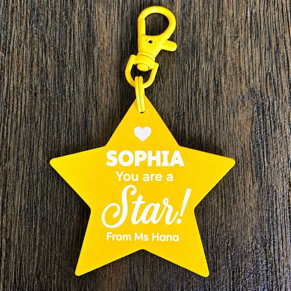 Yellow "You are a Star" keychain with a student's name and the teacher's name