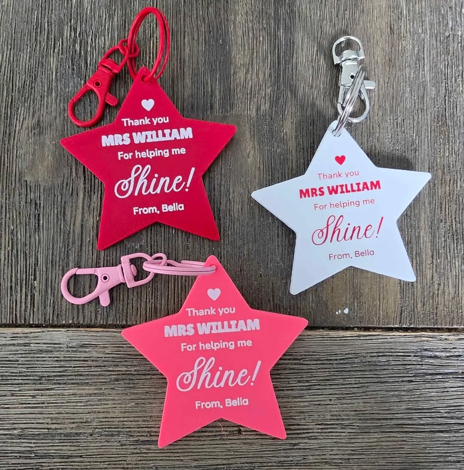 Red, pink and white star keychains with teacher thank-you messages and matching clips