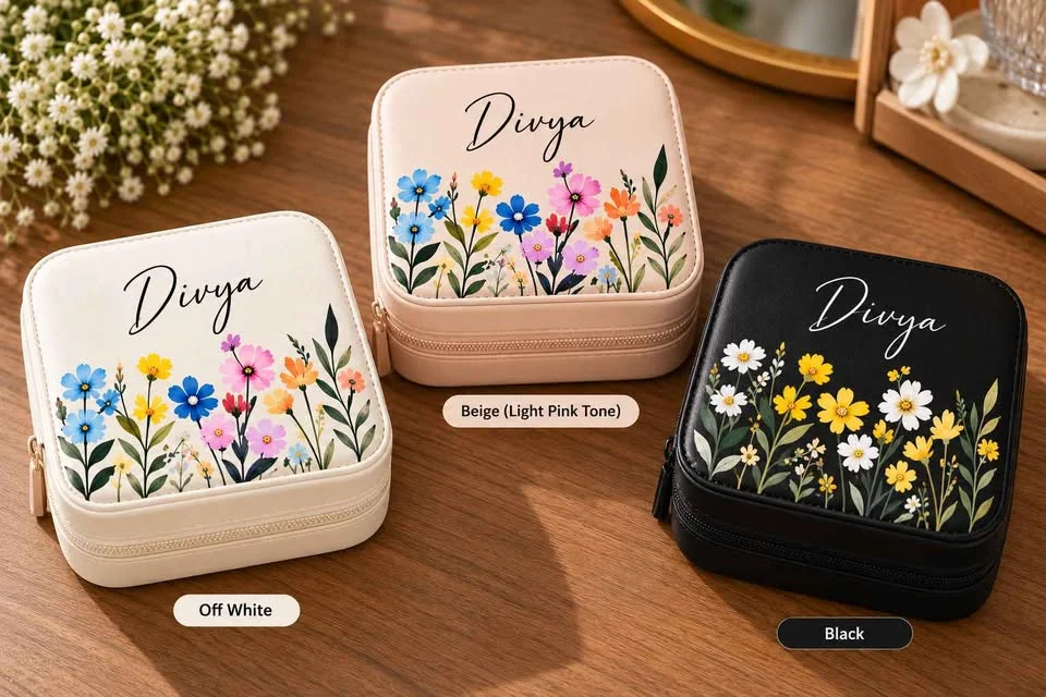 The three box colours side by side: off-white, beige pink and black, each with a name and flowers