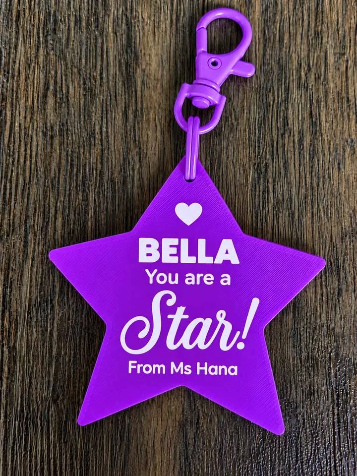 Purple "You are a Star" keychain with a student's name and the teacher's name