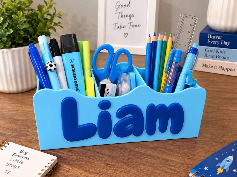 Illustration: light blue desk organiser with a navy name, filled with stationery