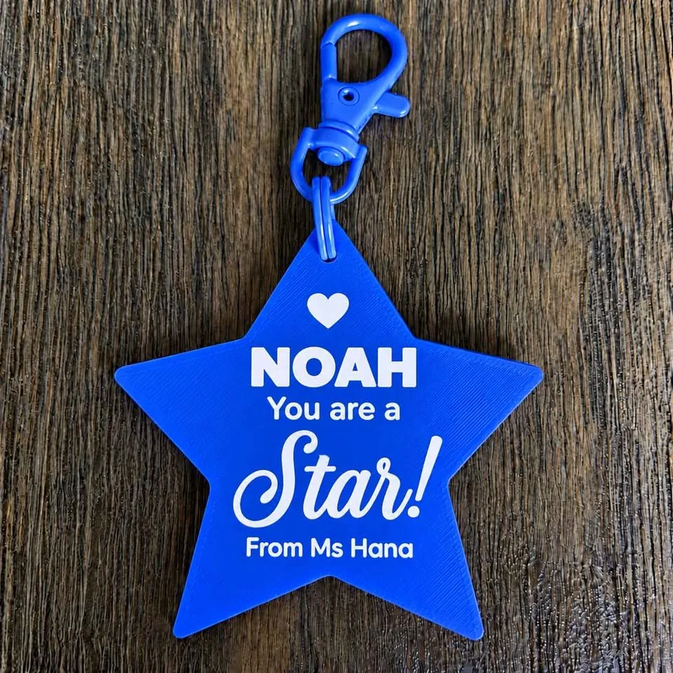 Blue "You are a Star" keychain with a student's name and the teacher's name